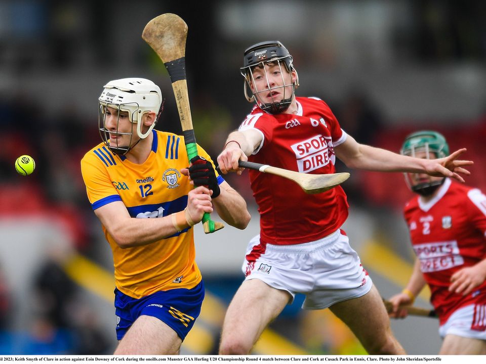 19 April 2023; Keith Smyth of Clare in action against Eoin Downey of Cork during the oneills.com Munster GAA Hurling U20 Championship Round 4 match between Clare and Cork at Cusack Park in Ennis, Clare. Photo by John Sheridan/Sportsfile