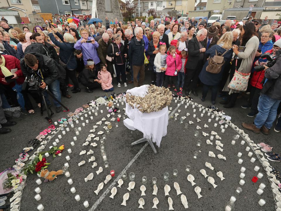 People gather to protest at the site of the former Tuam home, where a mass grave of around 800 babies was uncovered (Niall Carson/PA)
