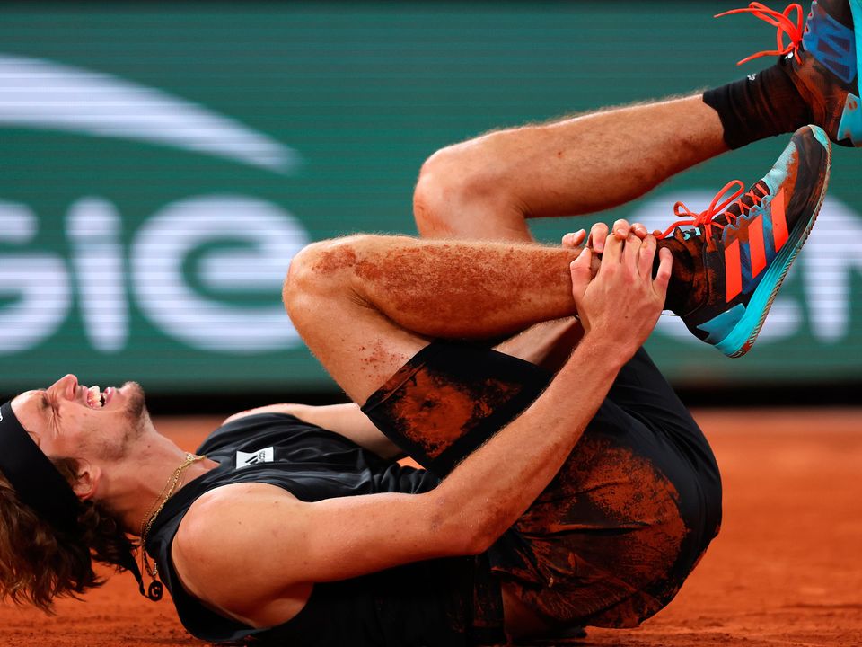 Alexander Zverev of Germany lies injured against Rafael Nadal of Spain during the Men's Singles Semi Final (Photo by Clive Brunskill/Getty Images)