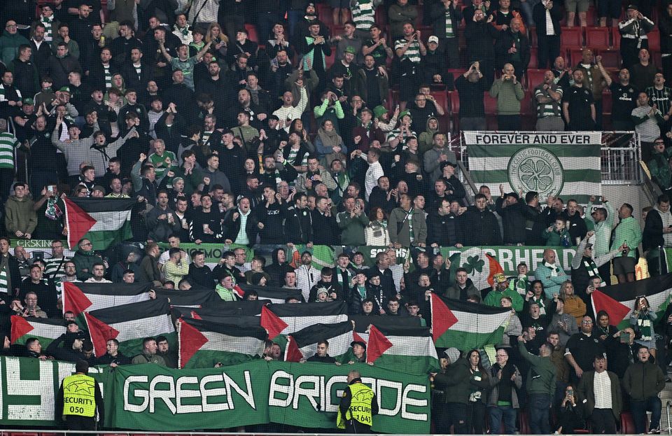 Celtic fans hold up Palestinian flags during the UEFA Champions League Group E soccer match between Atletico Madrid and Celtic at Civitas Metropolitano stadium in Madrid, Spain, November 7, 2023. (Photo by Burak Akbulut/Anadolu via Getty Images)