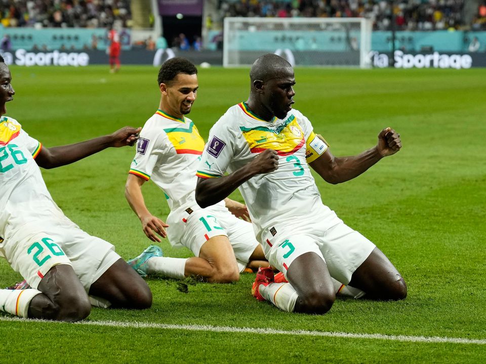 Senegal's Kalidou Koulibaly, right, celebrates with teammates scoring his side's second goal during the World Cup group A soccer match between Ecuador and Senegal, at the Khalifa International Stadium in Doha, Qatar, Tuesday, Nov. 29, 2022. (AP Photo/Francisco Seco)
