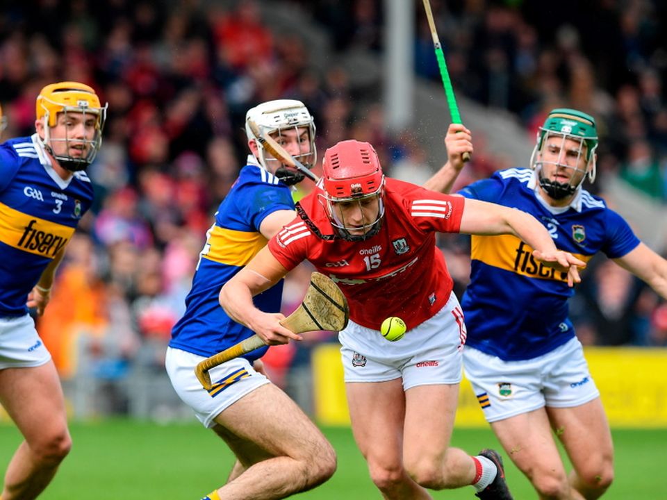 Alan Connolly of Cork in action against Craig Morgan and Cathal Barrett of Tipperary