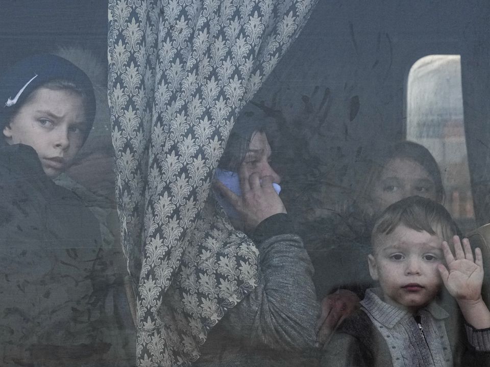 Internally displaced people look out from a bus at a refugee centre in Zaporizhia, Ukraine, in March 2022 (Evgeniy Maloletka/AP/PA)