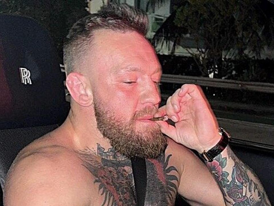 McGregor smoking in a Rolls Royce