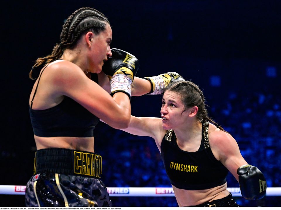 25 November 2023; Katie Taylor, right, and Chantelle Cameron during their undisputed super lightweight championship bout at the 3Arena in Dublin. Photo by Stephen McCarthy/Sportsfile