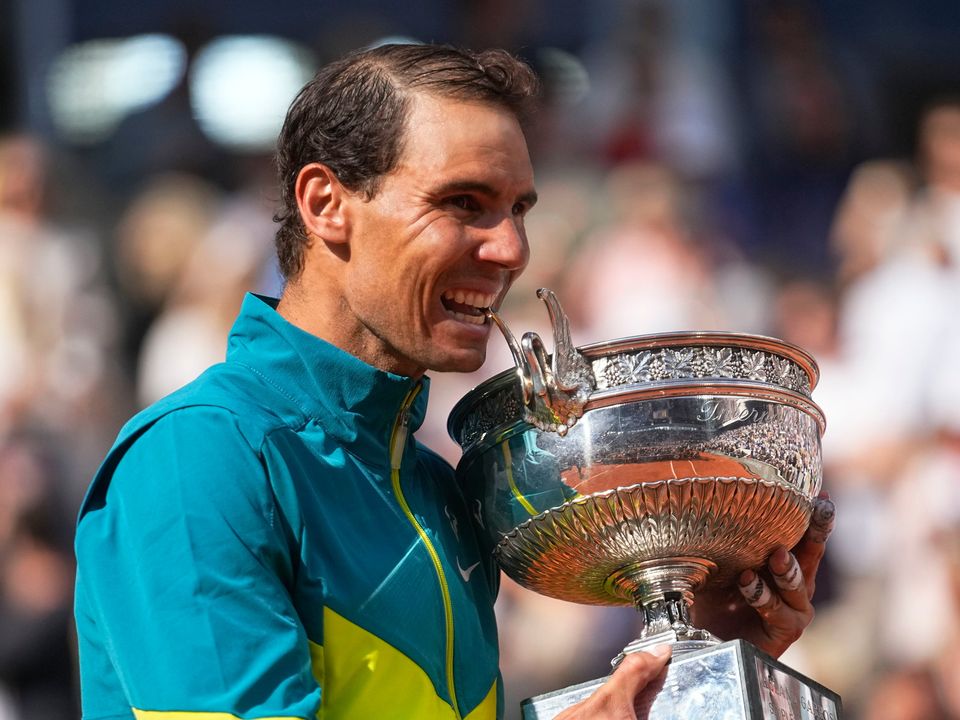 Spain's Rafael Nadal bites the trophy after winning the final match against Norway's Casper Ruud in three sets, 6-3, 6-3, 6-0, at the French Open tennis tournament in Roland Garros stadium in Paris