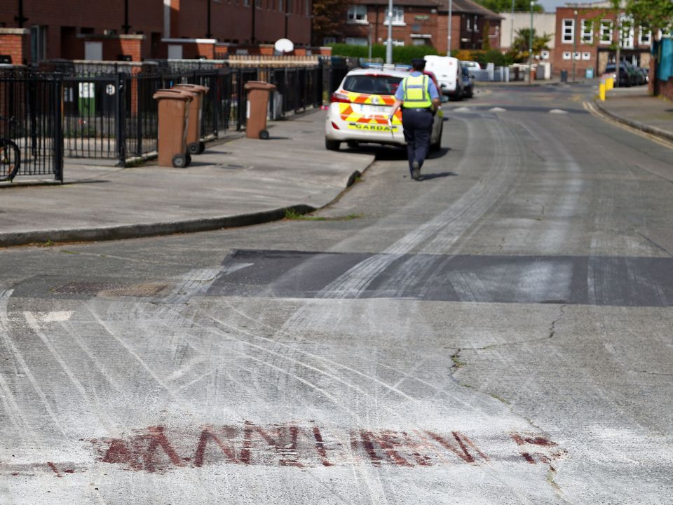 Blood is visible on the road as gardaí continue their investigations into the gangland shooting on Knocknarea Road, Drimnagh. Photo: Collins