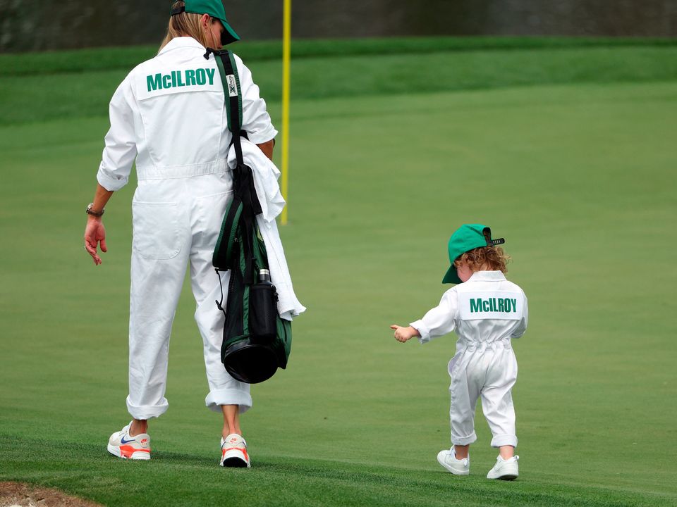 Rory's wife and daughter play caddie for daddy at yesterday's Par 3 event