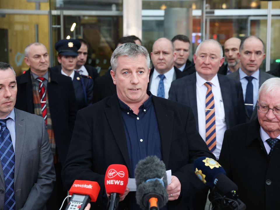 Brendan Horkan (centre) and Marty Horkan (right), as family of Detective Garda Colm Horkan make a statement outside the Criminal Courts of Justice.