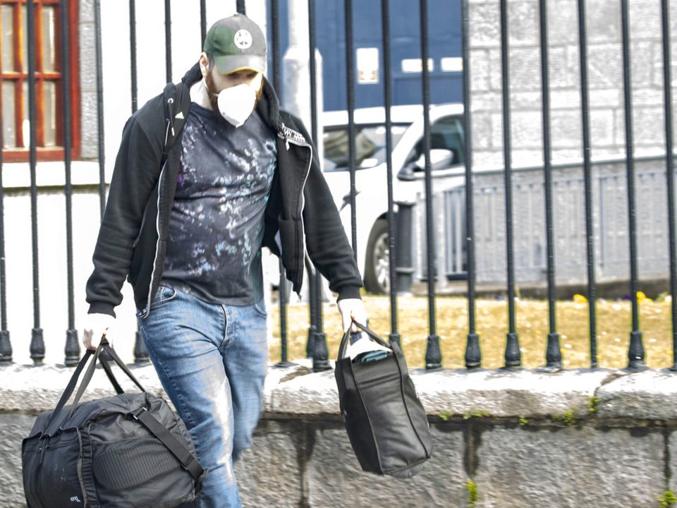 Keith Burke carries his belongings from prison