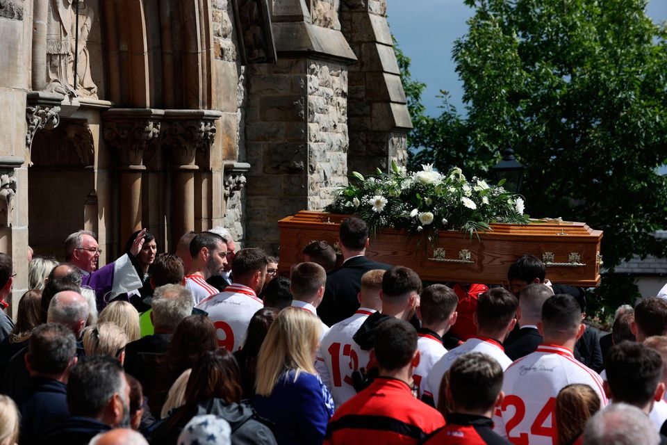 The Very Rev Dan Kevin Donaghy blesses the coffin as it arrives at St Patrick's Church, Dungannon, County Tyrone, for the funeral for GAA star Damian Casey, following the death of the Tyrone hurling captain was attending a friend's wedding in Spain when he died in an incident in a swimming pool last week. Picture date: Sunday June 26, 2022. PA Photo. See PA story ULSTER Casey. Photo credit should read: Liam McBurney/PA Wire