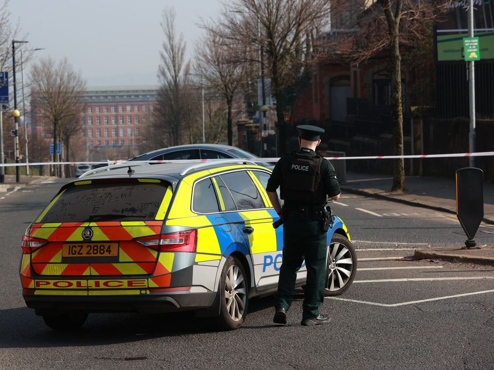 PSNI officers patrol a cordon at the Holy Cross church where emergency services attended a security alert on March 25 (Liam McBurney/PA)