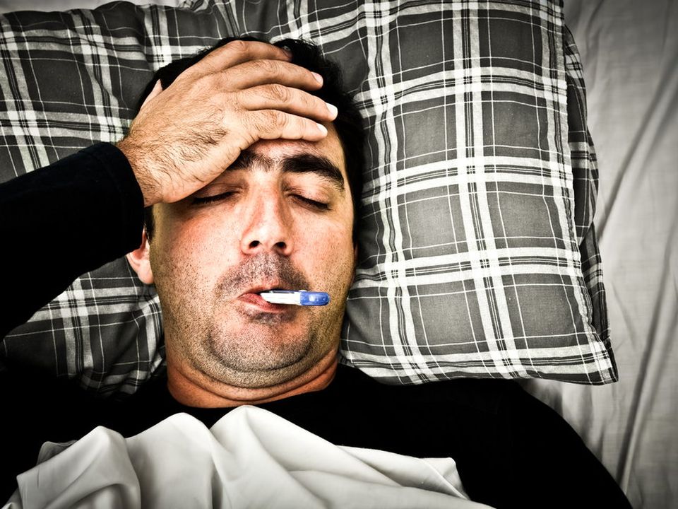 Man sick in bed (stock)