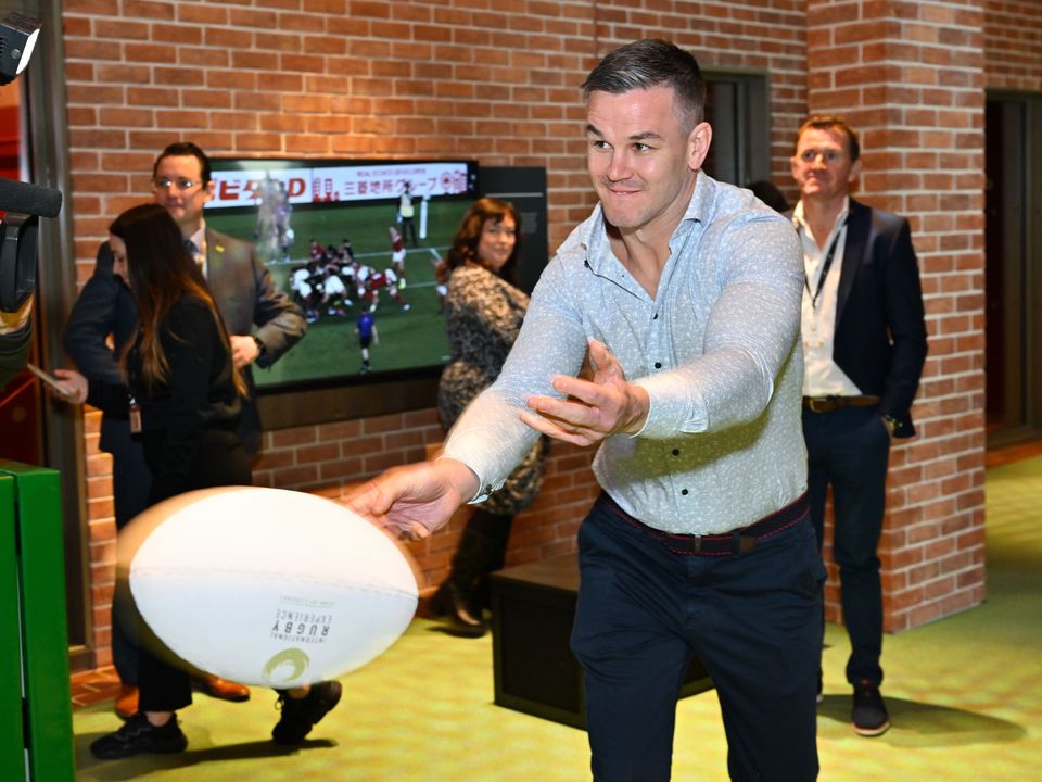 Jonathan Sexton tests his passing skills at the opening of the International Rugby Experience in Limerick.