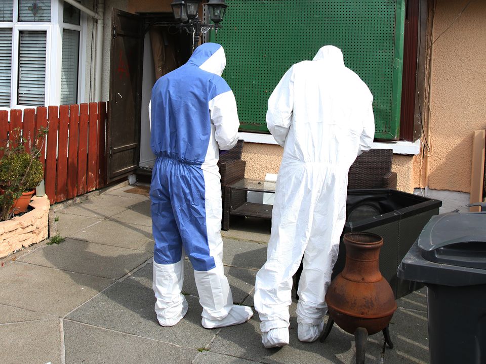 Forensic police at the scene of the murder