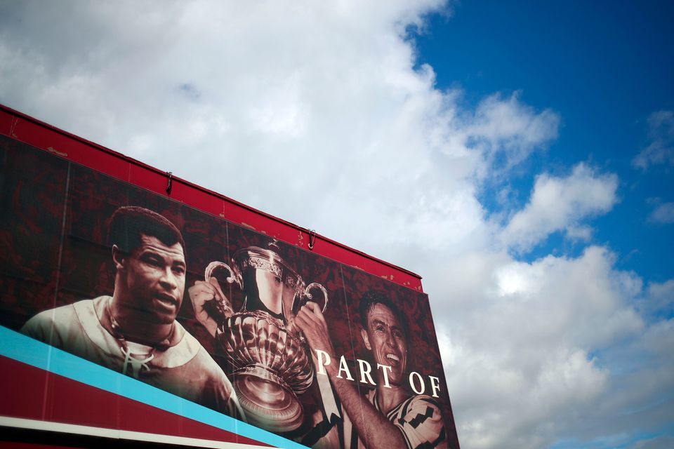 Former Aston Villa players Johnny Dixon (right) with the FA Cup trophy and Paul McGrath on a hoarding at Villa Park. Photo: Marc Atkins/Getty Images