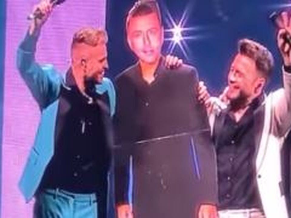 Westlife and the cardboard replacement for Mark Feehily while he recovers from pneumonia.
