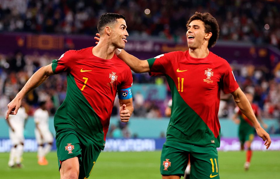 DOHA, QATAR - NOVEMBER 24: Cristiano Ronaldo of Portugal celebrates with Joao Felix after scoring their team's first goal via a penalty   during the FIFA World Cup Qatar 2022 Group H match between Portugal and Ghana at Stadium 974 on November 24, 2022 in Doha, Qatar. (Photo by Clive Brunskill/Getty Images)