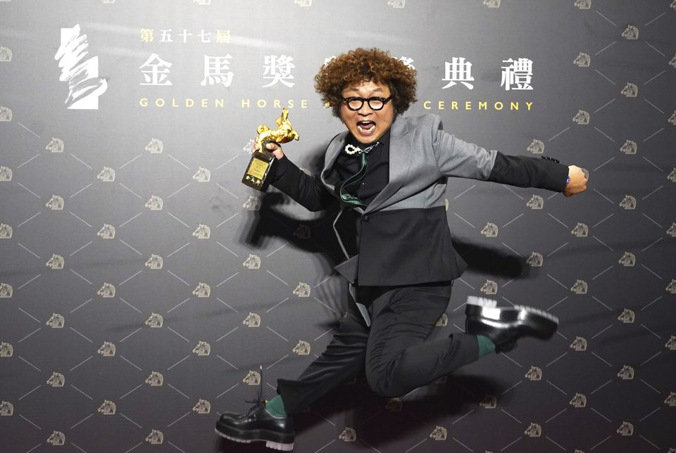 Taiwanese actor Nadow Lin with his best supporting actor trophy (Billy Dai/AP)