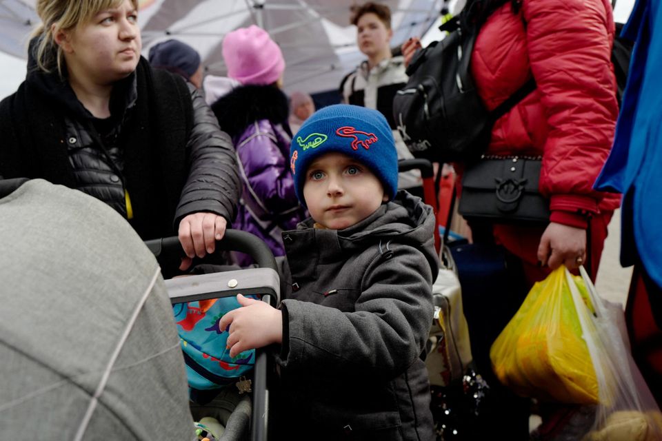 Ukrainian refugees in Medyka, Poland, last week queue to get the bus after crossing the Ukraine-Poland border. Picture by Kacper Pempel