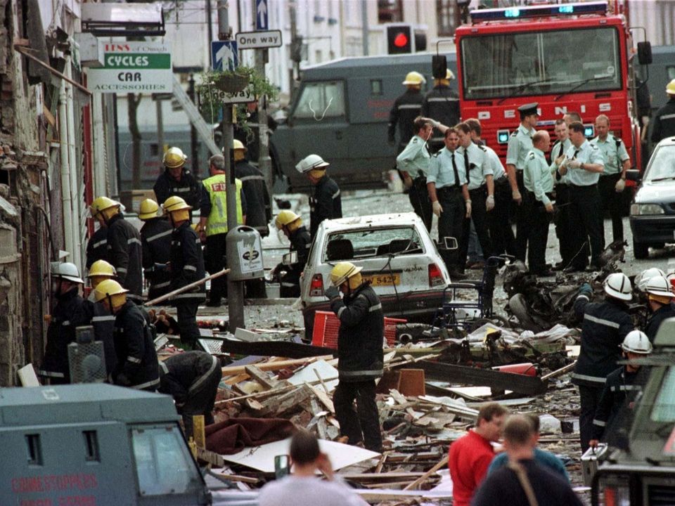 Police officers and firefighters inspecting the carnage caused by a bomb in Market Street, Omagh in  2009.