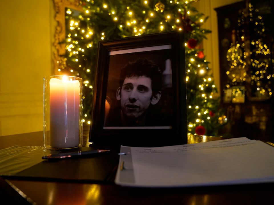A candle burns next to a photograph of The Pogues frontman Shane MacGowan at the Mansion House, in Dublin, after a book of condolence was open by the Lord Mayor of Dublin, following the announcement of the singers death aged 65
