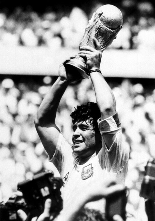 Diego Maradona holds up the World Cup after Argentina beat West Germany in the World Cup final in Mexico in 1986 (PA)