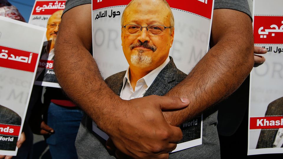 People hold posters of murdered Saudi journalist Jamal Khashoggi, near the Saudi Arabia consulate in Istanbul on the second anniversary of his death (Emrah Gurel/AP)