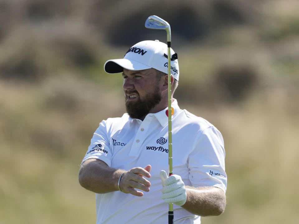 Shane Lowry of Ireland follows his ball on the 1st hole during the third round of Abu Dhabi HSBC Golf Championship, in Abu Dhabi, United Arab Emirates, Saturday, Jan. 21, 2023. (AP Photo/Kamran Jebreili)