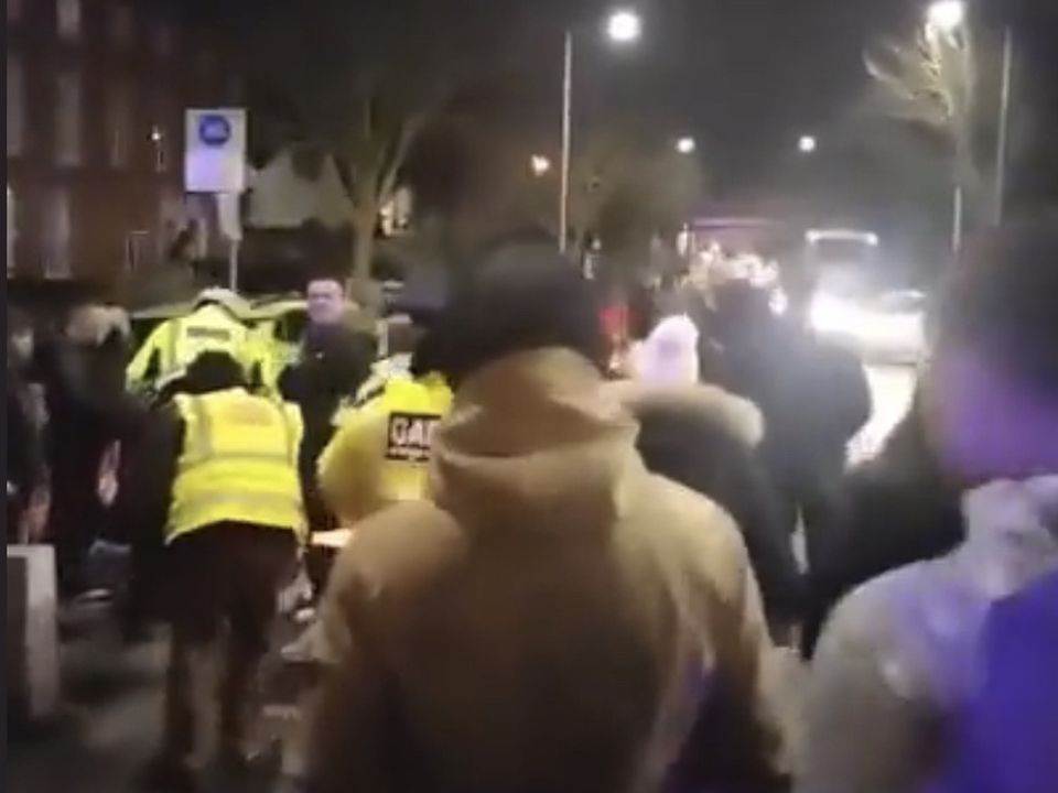 Gardai surround the car following the incident at an anti-migration rally