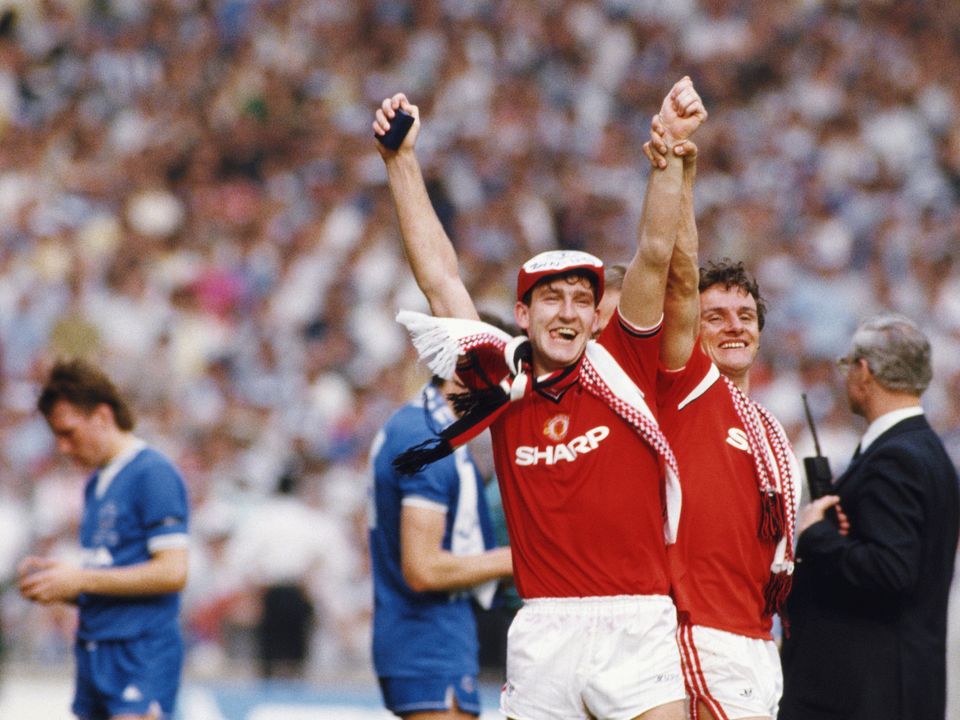 LONDON, UNITED KINGDOM - MAY 18: Winning goalscorer Norman Whiteside (c) celebrates with defender Kevin Moran as Everton winger Trevor Steven (l) reacts after the 1985 FA Cup Final between Manchester United and Everton at Wembley Stadium on May 18, 1985 in London, England.  (Photo by David Cannon/Allsport/Getty Images)