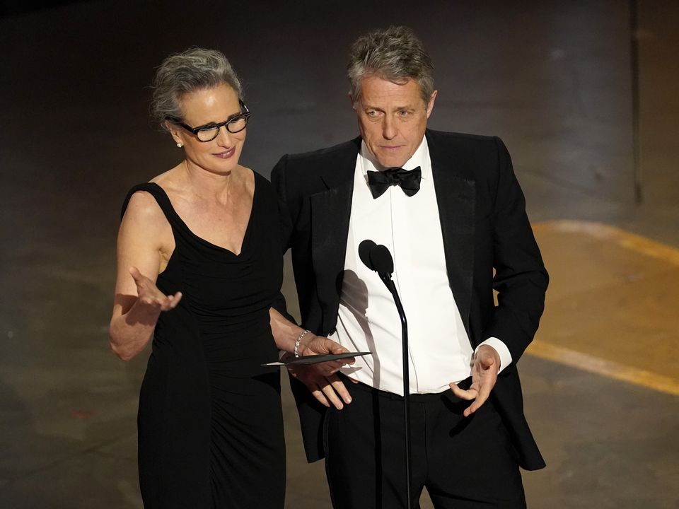 Andie MacDowell, left, and Hugh Grant present the award for best production design at the Oscars on Sunday, March 12, 2023, at the Dolby Theatre in Los Angeles (Chris Pizzello/AP)
