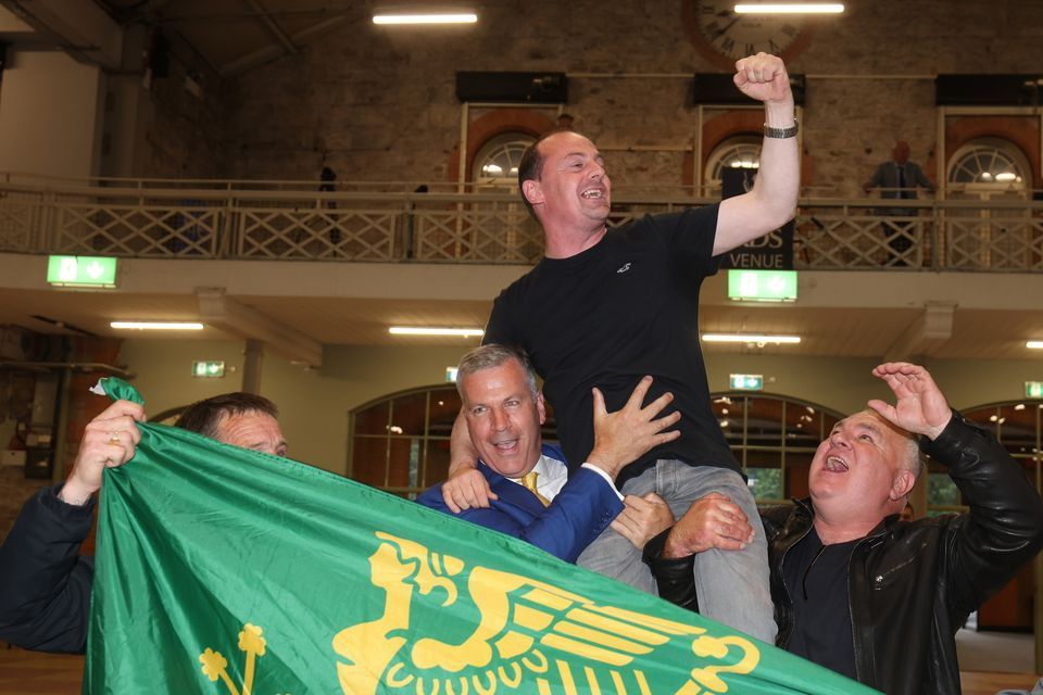 Gavin Pepper is hoisted by Hermann Kelly, left, of the Irish Freedom Party