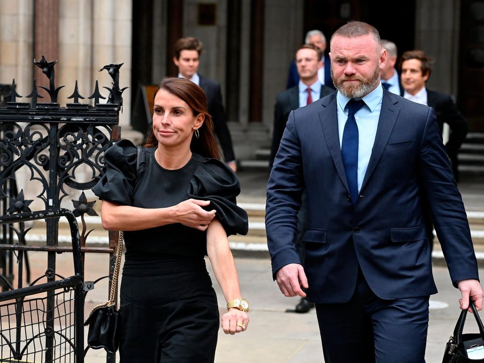 Coleen Rooney leaves the Royal Courts of Justice in London with husband Wayne Rooney yesterday. Photo: Kate Green/Getty Images