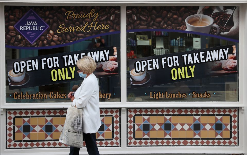 A woman walks past a cafe in Co Cavan, one of the counties on Level 4 of the response to coronavirus framework (Brian Lawless/PA)