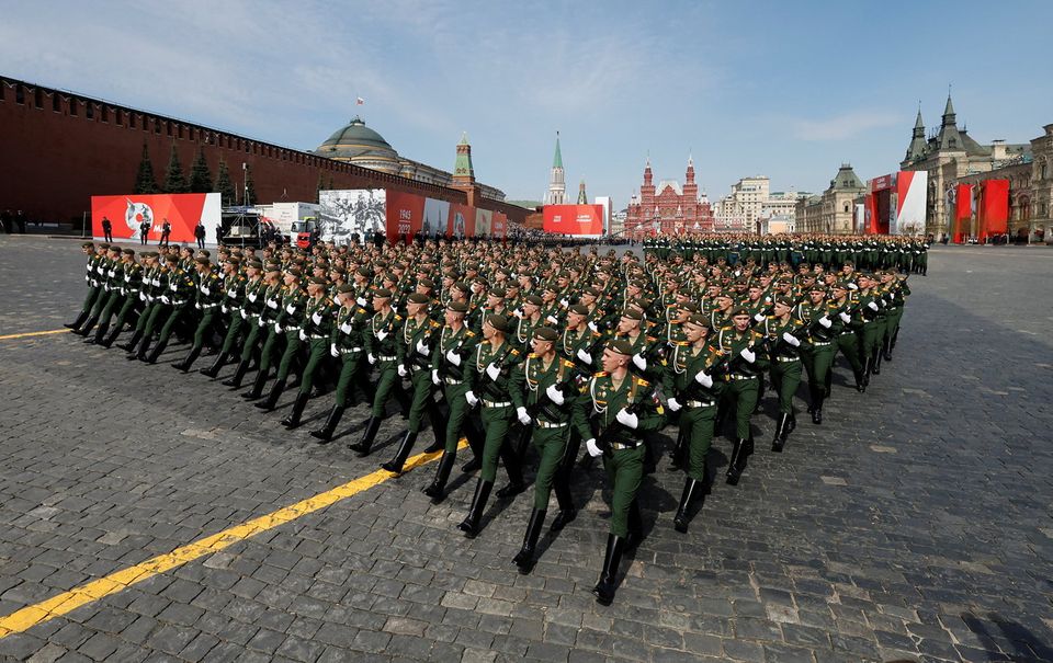 Russian service members march in Red Square