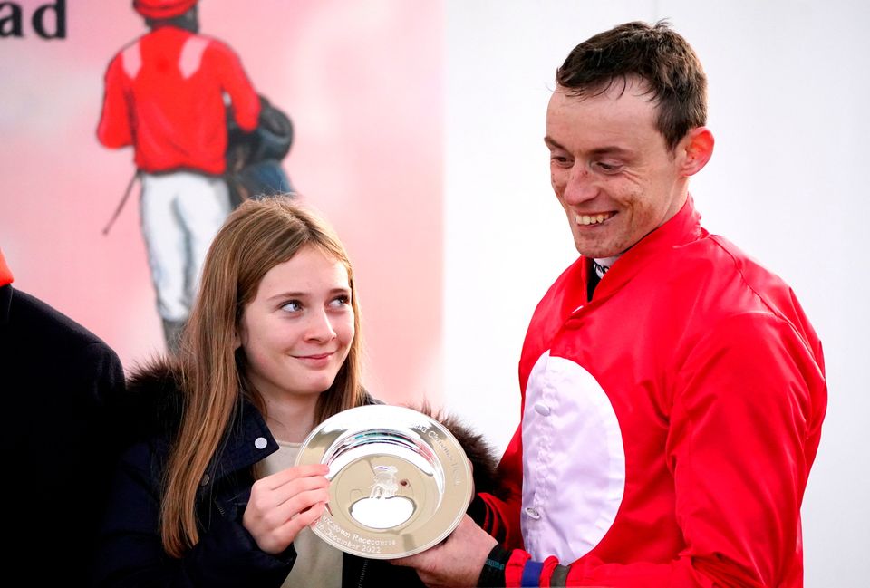 Georgia de Bromhead presents JJ Slevin with the trophy after winning the Jack de Bromhead Christmas Hurdle on Home By The Lee. Photo: Niall Carson/PA Wire.