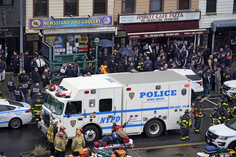 Emergency personnel gather at the entrance to the subway stop (AP)