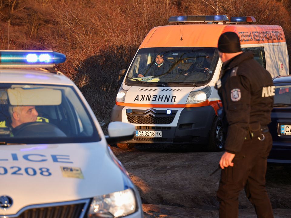 An ambulance leaves the site where the bodies were found. Photo: Stoyan Nenov