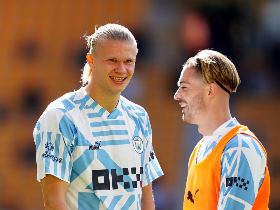 Manchester City's Erling Haaland (left) and Jack Grealish warming up ahead of during the Premier League match at Molineux Stadium, Wolverhampton. Picture date: Saturday September 17, 2022.
