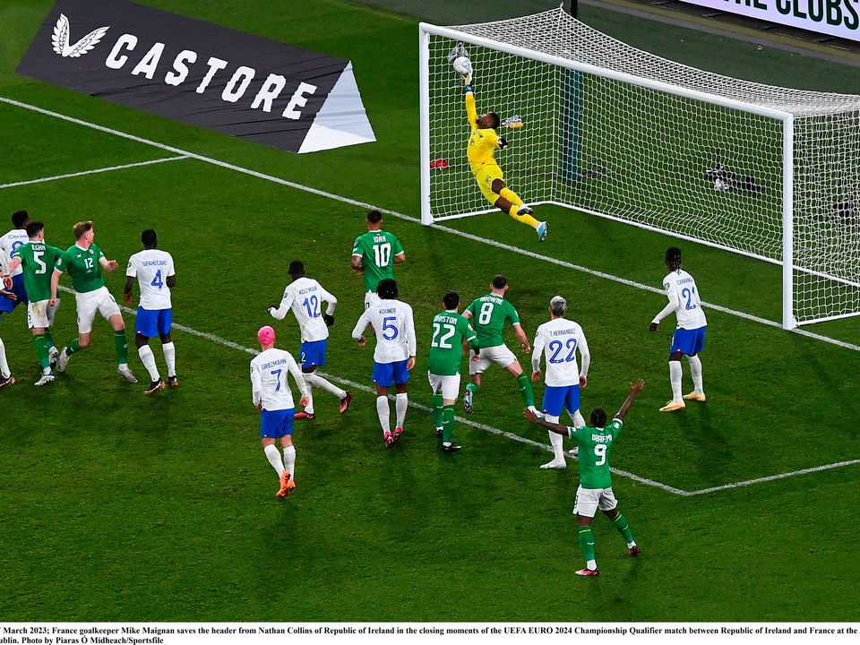 27 March 2023; France goalkeeper Mike Maignan saves the header from Nathan Collins of Republic of Ireland in the closing moments of the UEFA EURO 2024 Championship Qualifier match between Republic of Ireland and France at the Aviva Stadium in Dublin. Photo by Piaras Ó Mídheach/Sportsfile