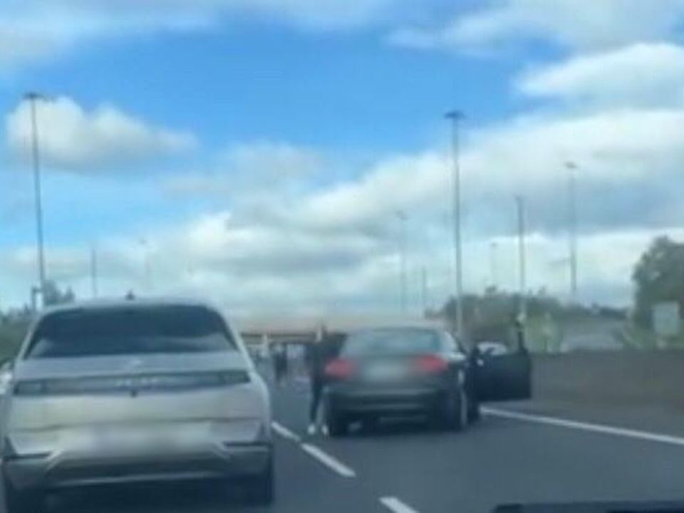 A man can be seen getting out of a car