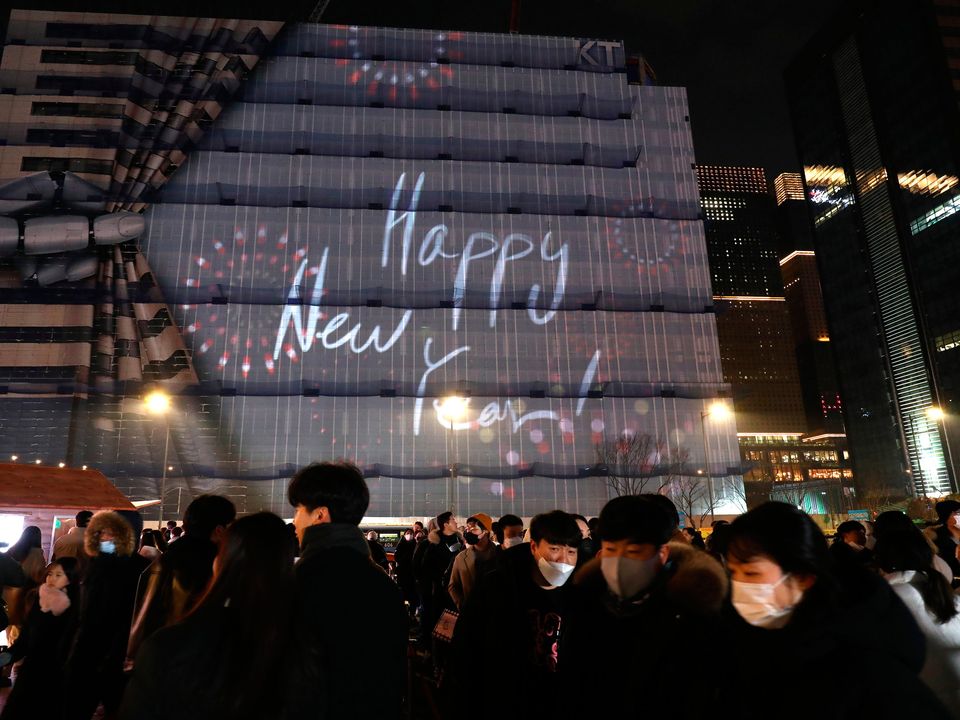 Members of the public gather to celebrate New Year's Eve at the Gwanghwamun Square on December 31, 2022 in Seoul, South Korea
