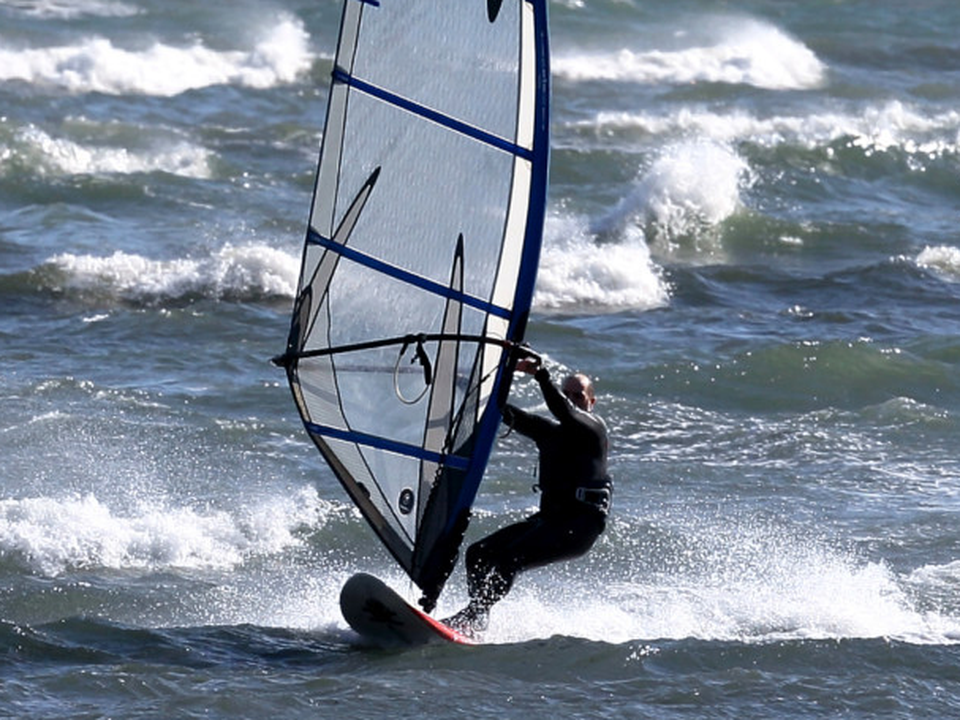 A windsurfer in choppy waters near the South Bull Wall