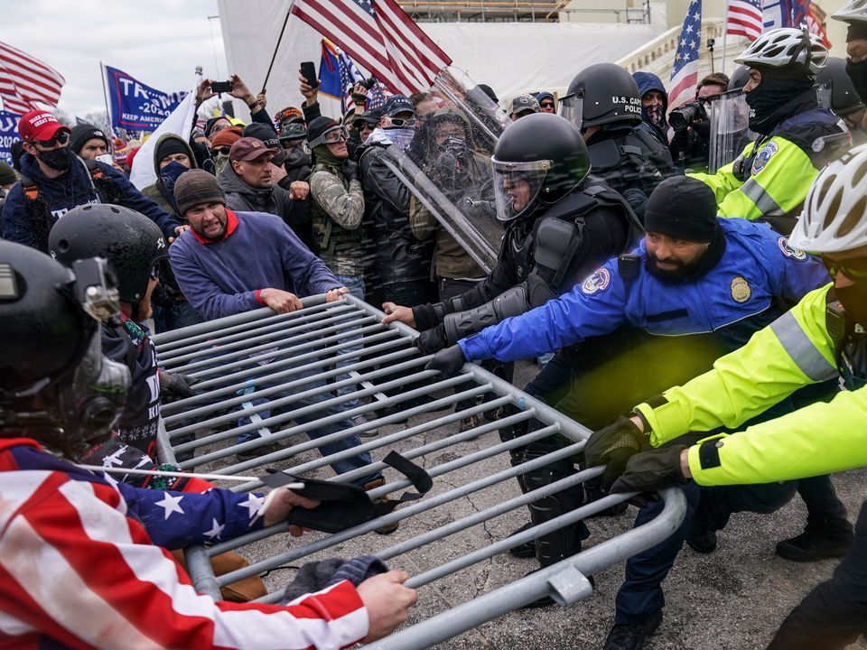 Trump supporters try to break through a police barrier during the January 6 riots in 2021