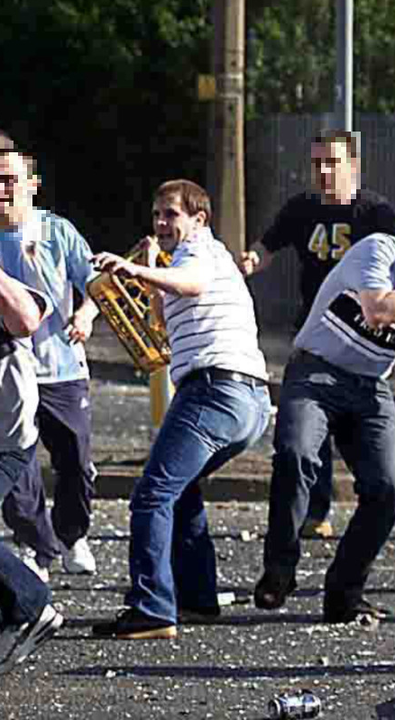 Winkie Irvine throwing an empty milk crate during rioting at Ardoyne after a Celtic-Rangers game in 2005
