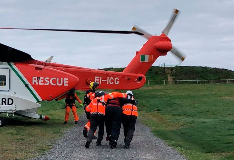 Malin Head Coast Guard photo of an Irish Coast Guard helicopter taking part in a multi-agency operation to rescue a man from a sea cave in Co Mayo. Photo: PA