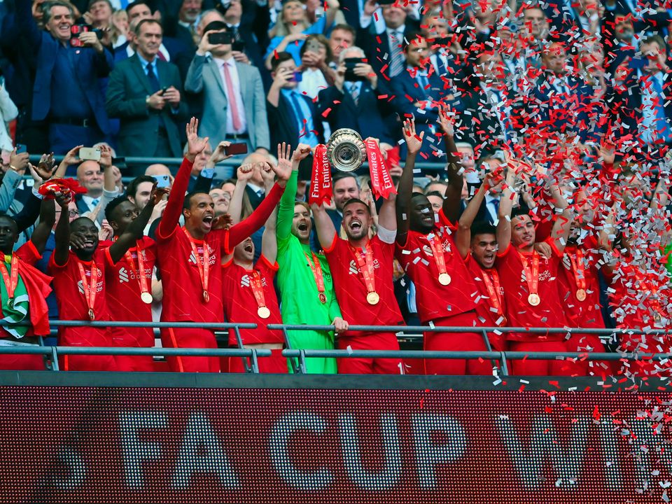 Jordan Henderson of Liverpool lifts The FA Cup trophy after their sides victory during The FA Cup Final. (Photo by Shaun Botterill/Getty Images)
