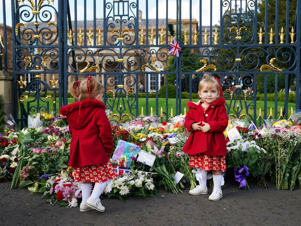 ***PARENTAL PERMISSION GIVEN**** Twins Abigail and Arabella Glen (2), from Lisburn, at the gates of Hillsborough Castle, Co. Down, following the death of Queen Elizabeth II on Thursday. Picture date: Saturday September 10, 2022.