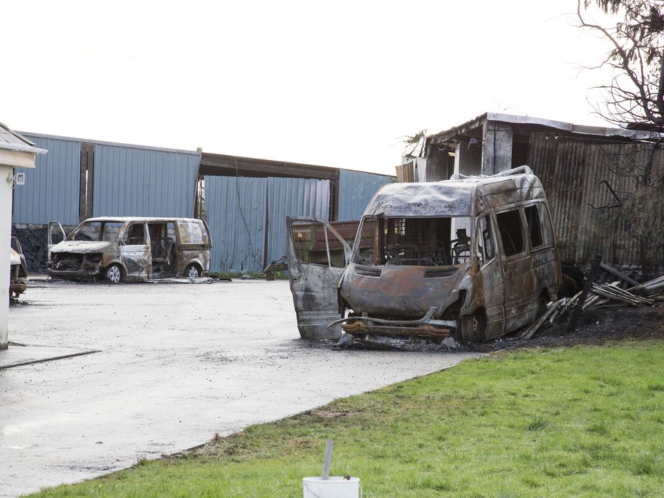 Burnt-out vehicles at the repossessed home of Michael Anthony McGann near Strokestown, Co Roscommon. Photo: Colin O'Riordan